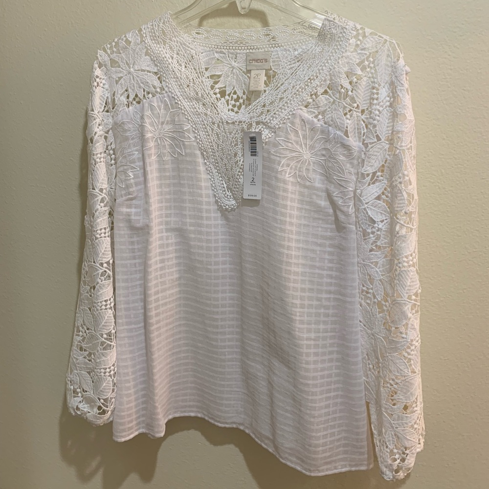 Chico’s size 2P (L/12) long sleeved patterned and lace top. Brand new!